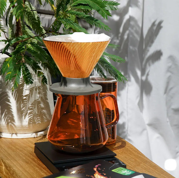 Hario V60 Dripper NEO 02 Pour-Over Brewer in Bernstein (Amber) beim Aufguss auf einer Glaskaraffe