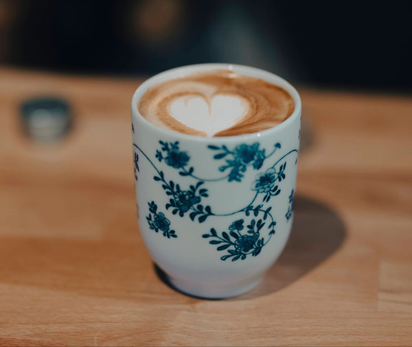 coffee cup with a flat white made with oat milk at the Coffee Coaching Club