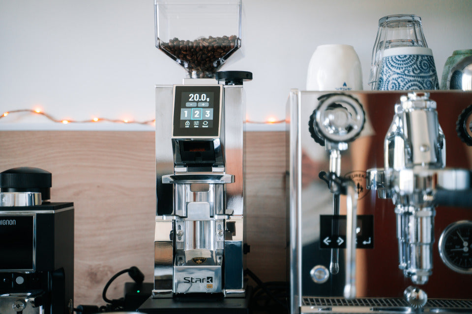 Eureka Mignon Stark W Chrom auf der Küchentheke neben einer Espressomaschine – Coffee Coaching Club 18