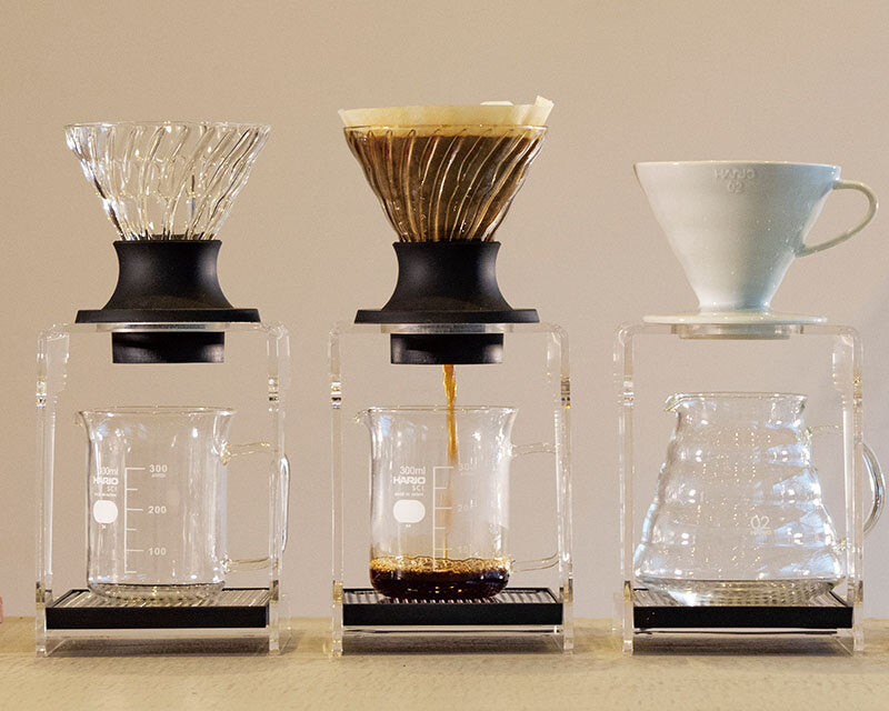 Zwei Hario V60 Switch Glas neben einem klassischen V60 auf Servern – Coffee Coaching Club 39