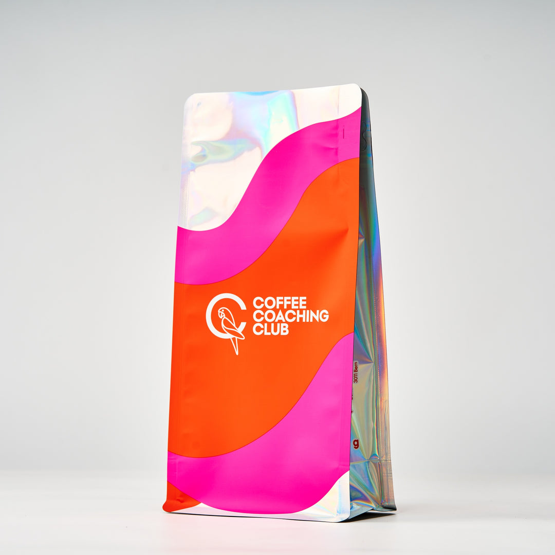 Wild Peach coffee beans – 250 g bag, side view with holographic gusset, pink and orange design – Coffee Coaching Club